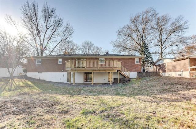 rear view of property with a lawn and a wooden deck