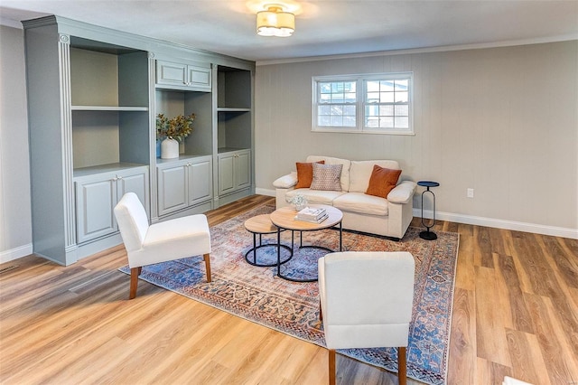 living room featuring hardwood / wood-style flooring and ornamental molding