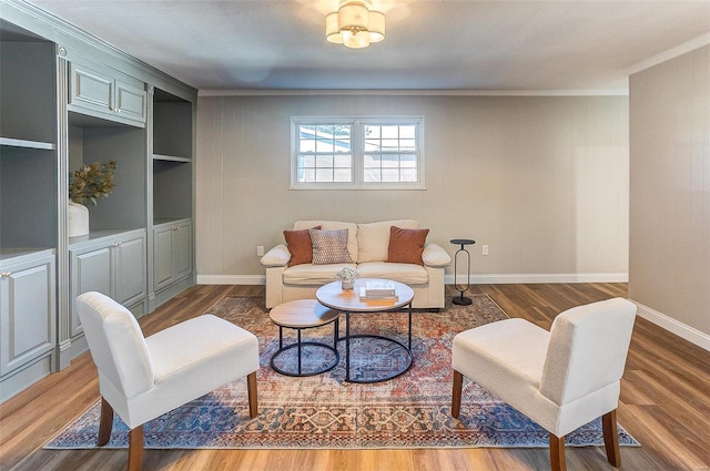 living room with hardwood / wood-style flooring and crown molding