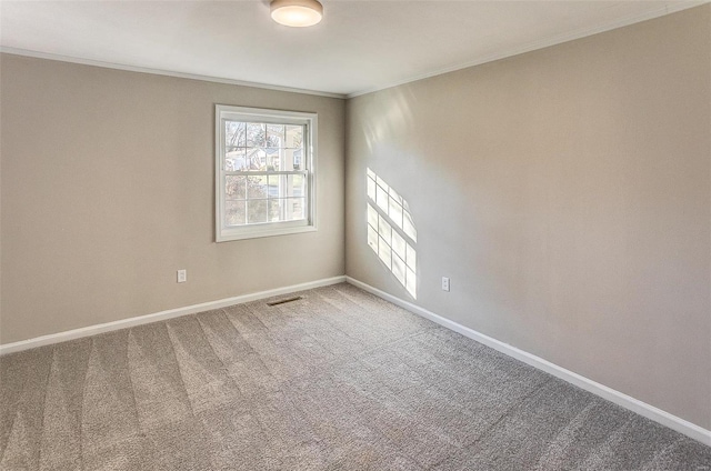 empty room with carpet flooring and ornamental molding