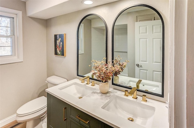 bathroom featuring hardwood / wood-style floors, vanity, and toilet