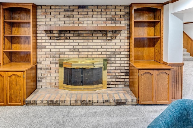 unfurnished living room with light colored carpet and a fireplace