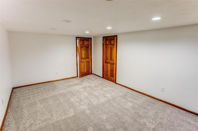 unfurnished room with light carpet