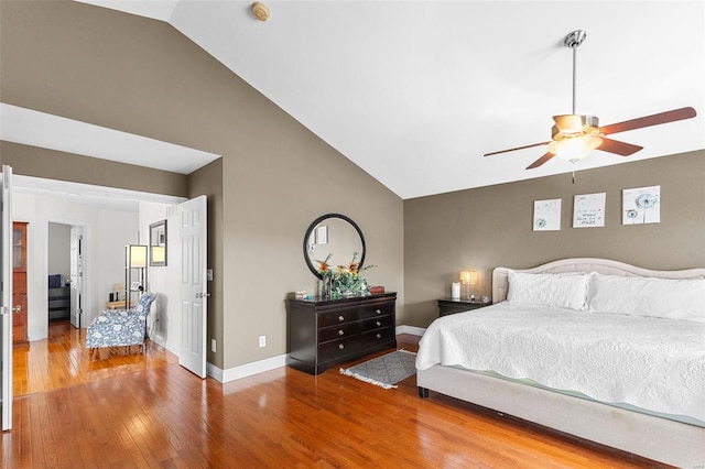 bedroom featuring ceiling fan, wood-type flooring, and lofted ceiling