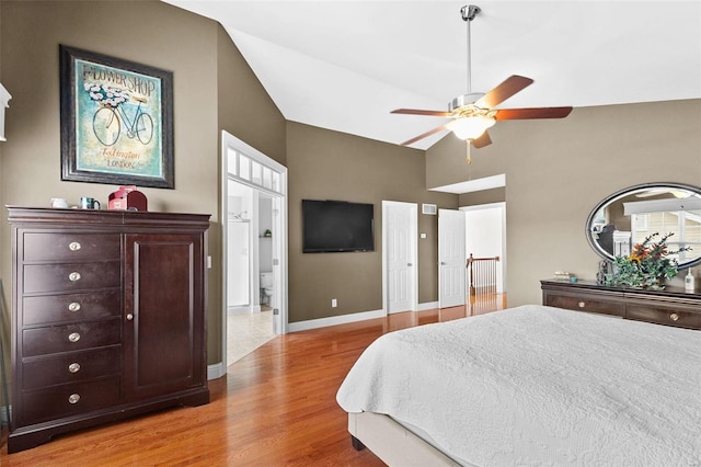 bedroom with light wood-type flooring, ensuite bath, ceiling fan, and lofted ceiling