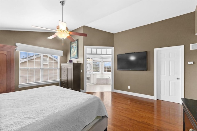 bedroom with dark hardwood / wood-style flooring, ensuite bathroom, vaulted ceiling, and ceiling fan