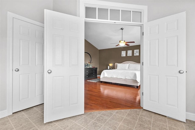 bedroom with ceiling fan and vaulted ceiling