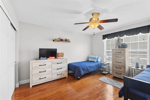 bedroom featuring hardwood / wood-style floors, ceiling fan, and a closet