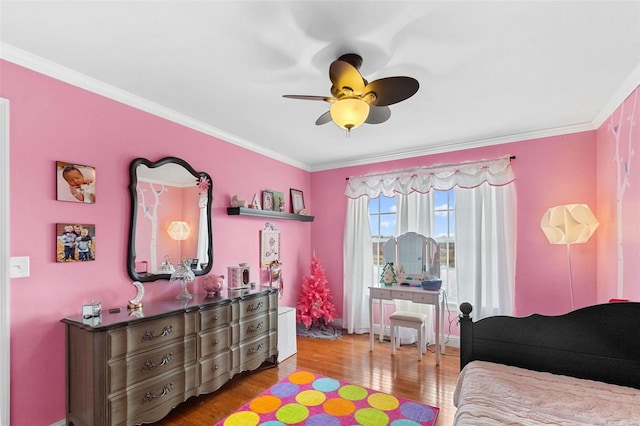 bedroom with wood-type flooring, ceiling fan, and crown molding