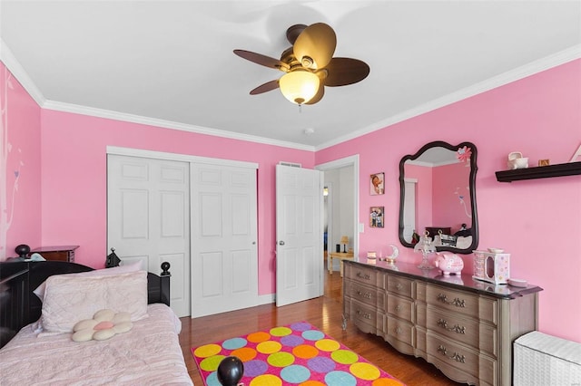 bedroom featuring a closet, ceiling fan, dark hardwood / wood-style flooring, and ornamental molding