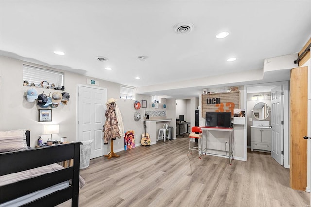 kitchen with a breakfast bar, decorative backsplash, and light wood-type flooring