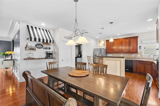 dining room with sink and dark wood-type flooring