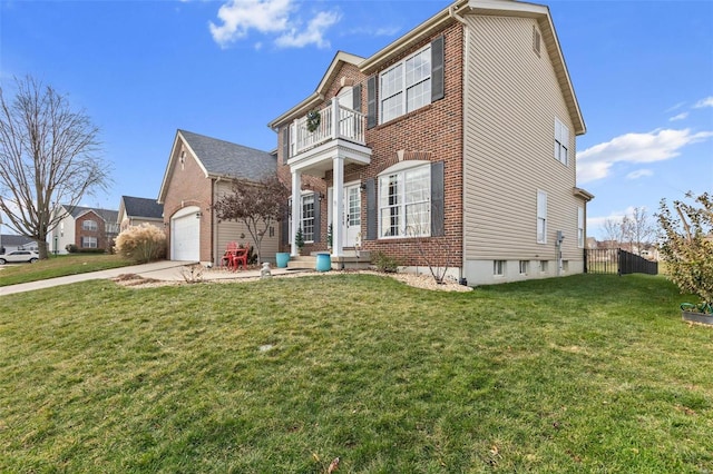 view of front of house featuring a garage, a balcony, and a front yard