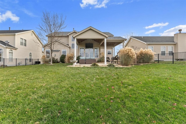 back of property with a lawn, outdoor lounge area, and a patio