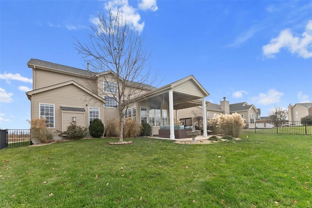 back of house featuring outdoor lounge area, a patio area, and a lawn