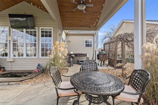 view of patio featuring ceiling fan and a hot tub