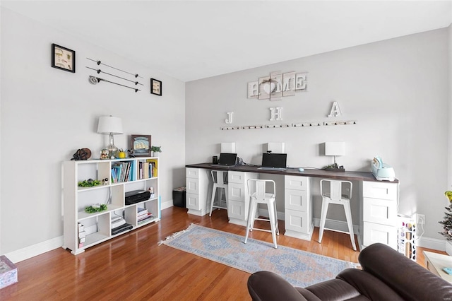 bar with white cabinetry and hardwood / wood-style flooring