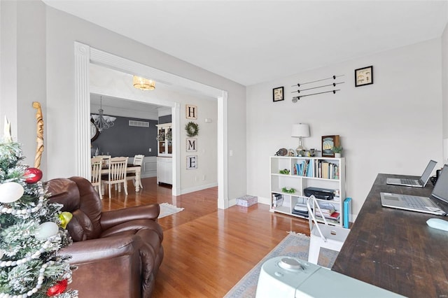 living room featuring hardwood / wood-style floors and an inviting chandelier