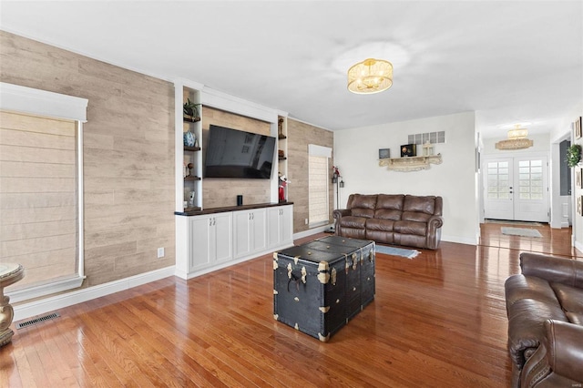 living room featuring wood-type flooring and french doors