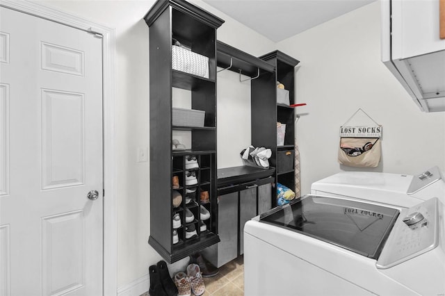 clothes washing area with cabinets, separate washer and dryer, and light tile patterned floors