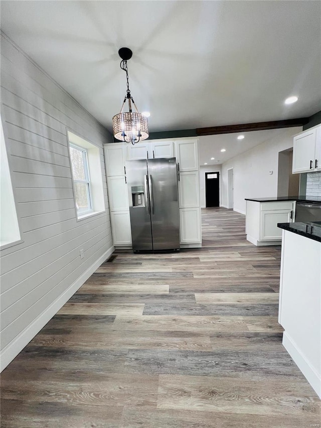 kitchen featuring a notable chandelier, white cabinetry, stainless steel appliances, and light hardwood / wood-style flooring