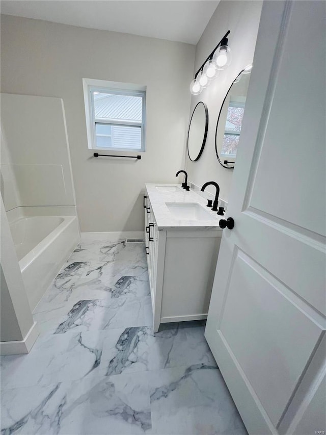 bathroom with plenty of natural light, shower / washtub combination, and vanity