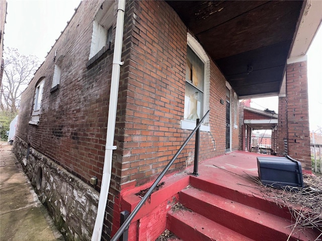 view of side of property with covered porch