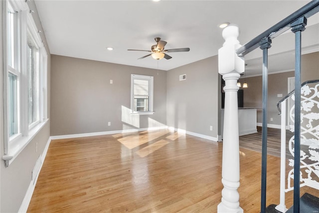 unfurnished living room with light wood-type flooring and ceiling fan