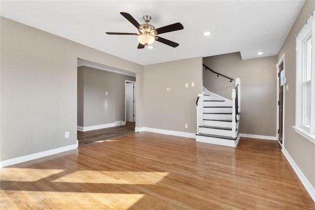 unfurnished living room with ceiling fan and wood-type flooring