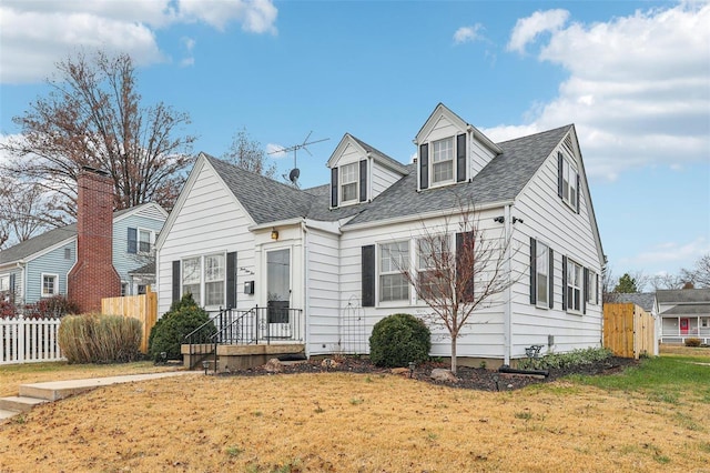 new england style home featuring a front yard