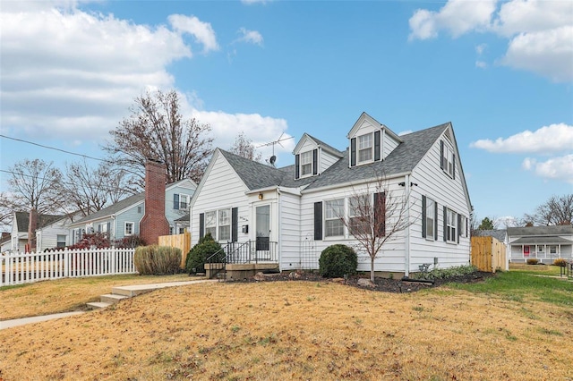 cape cod-style house featuring a front lawn