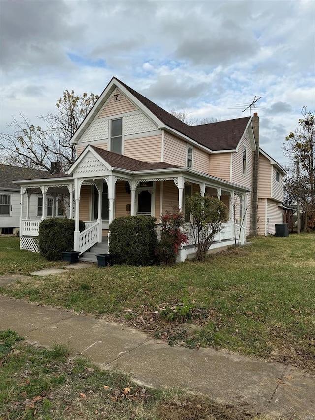 view of front of property with a porch, a front yard, and cooling unit