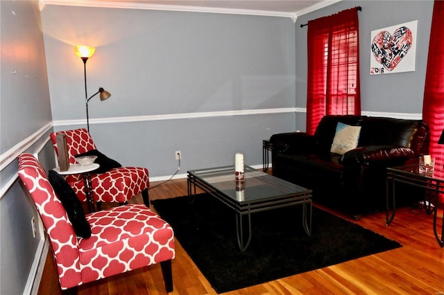 living room featuring wood-type flooring and ornamental molding