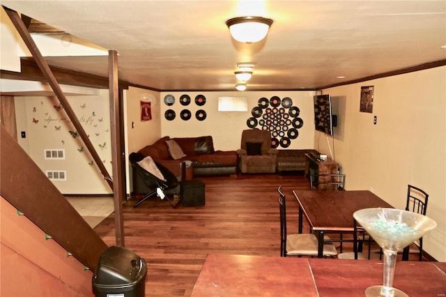 living room featuring crown molding and wood-type flooring