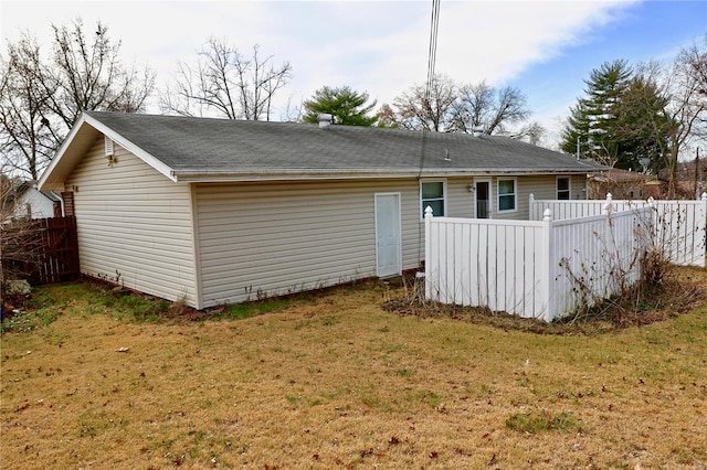 back of property featuring a yard