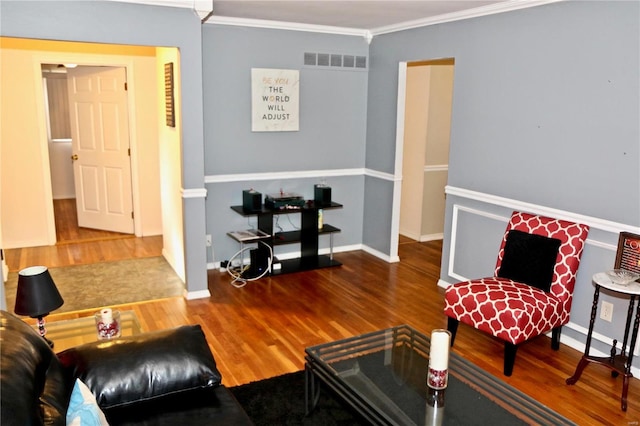 living room with crown molding and wood-type flooring