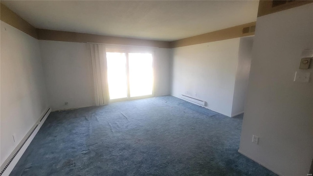 empty room featuring a baseboard radiator and dark carpet