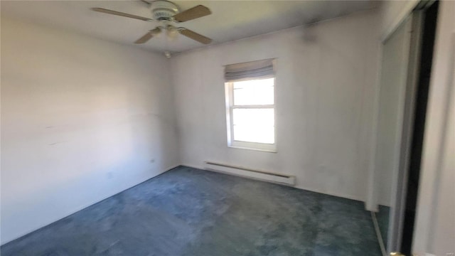 carpeted empty room featuring ceiling fan and a baseboard radiator