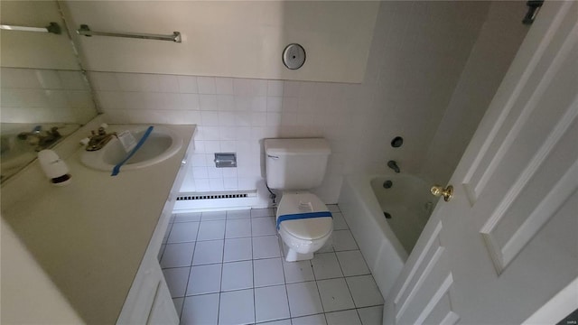 full bathroom with vanity, baseboard heating, tile patterned flooring, toilet, and tile walls