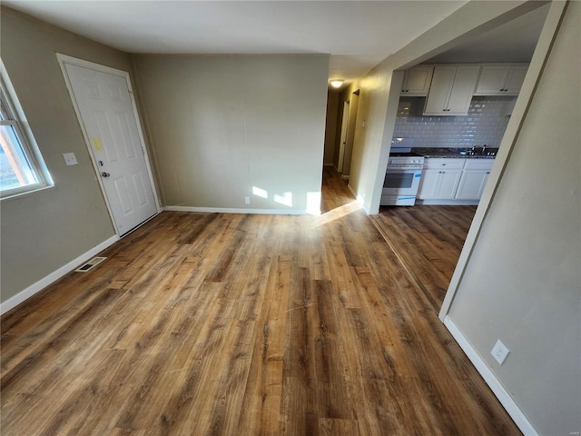 unfurnished living room with hardwood / wood-style floors