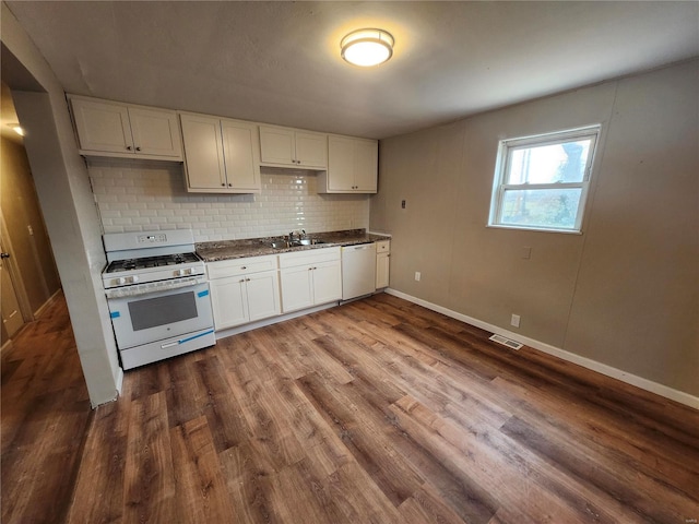 kitchen featuring sink, dark wood-type flooring, tasteful backsplash, white appliances, and white cabinets