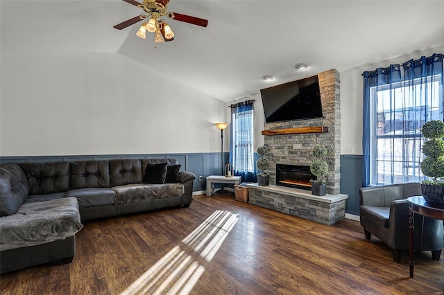 living room with lofted ceiling, a fireplace, ceiling fan, and dark hardwood / wood-style flooring