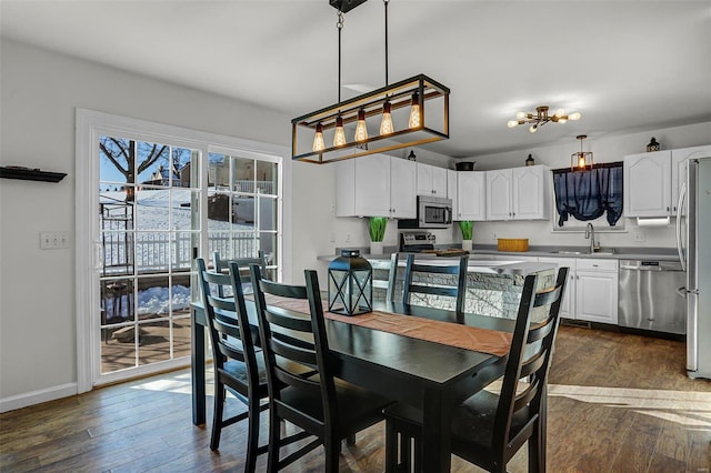 dining space featuring sink and dark hardwood / wood-style floors