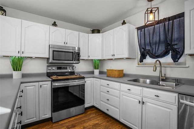 kitchen with stainless steel appliances, white cabinets, and sink