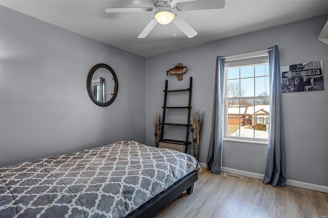 bedroom with ceiling fan and light hardwood / wood-style floors