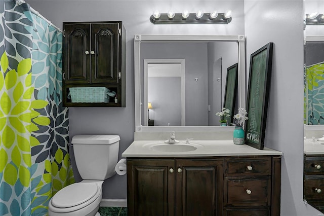 bathroom featuring toilet and vanity