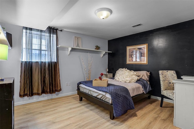 bedroom with light hardwood / wood-style floors