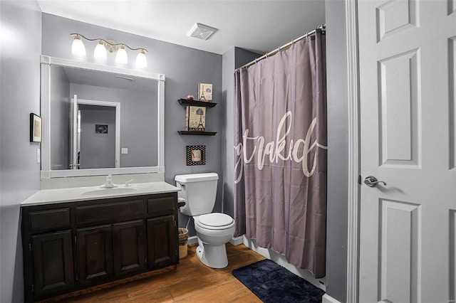 bathroom with toilet, wood-type flooring, vanity, and a shower with shower curtain