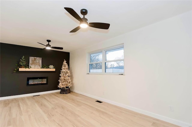 unfurnished room featuring hardwood / wood-style flooring and ceiling fan