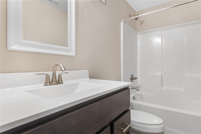 full bathroom featuring washtub / shower combination, vanity, and toilet